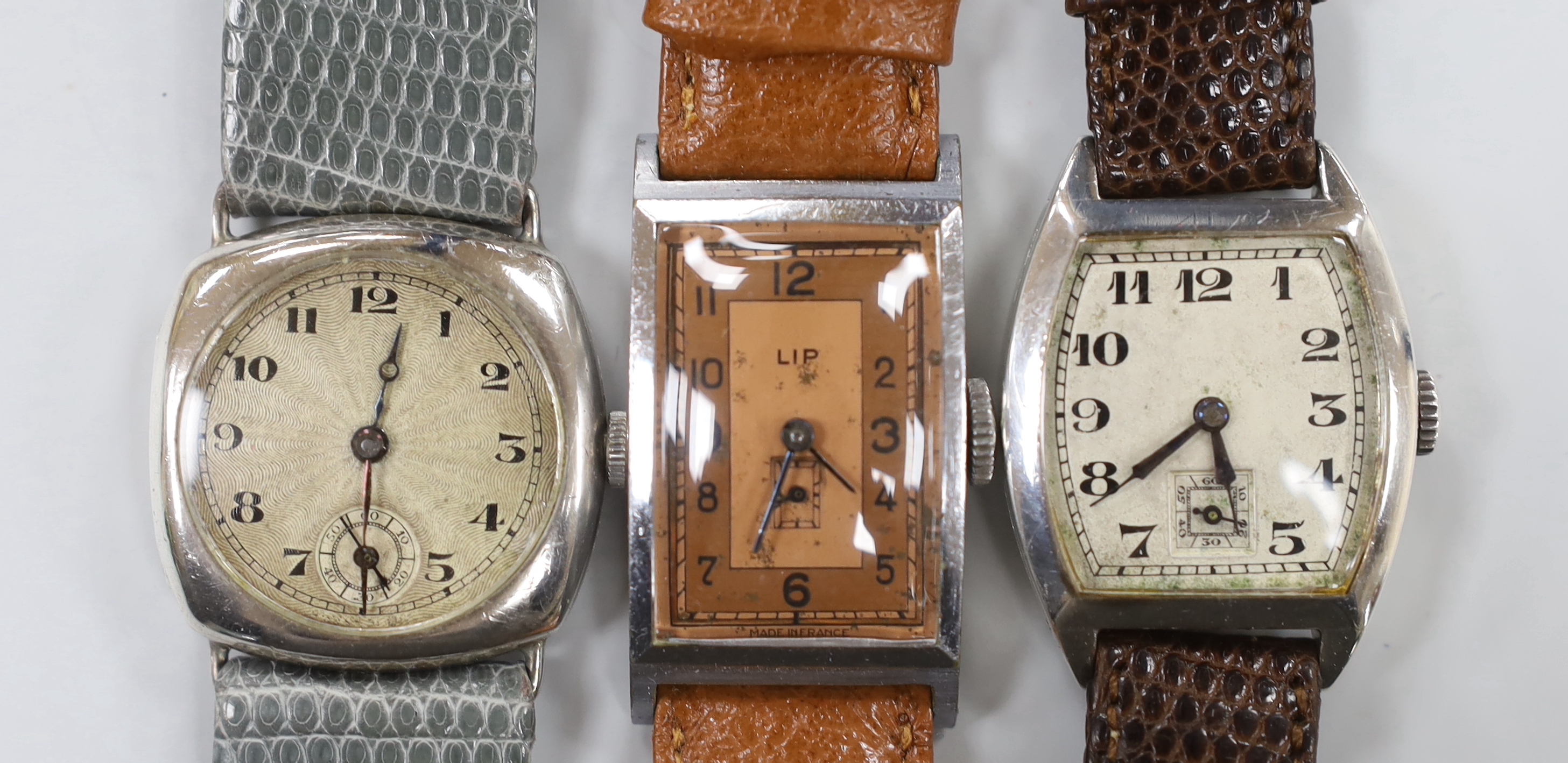 A gentleman's 1930's? silver manual wind wrist watch, with sunburst Arabic dial and subsidiary seconds, one other similar silver manual wind tonneau cased wrist watch and a stainless steel LIP manual wind wrist watch.